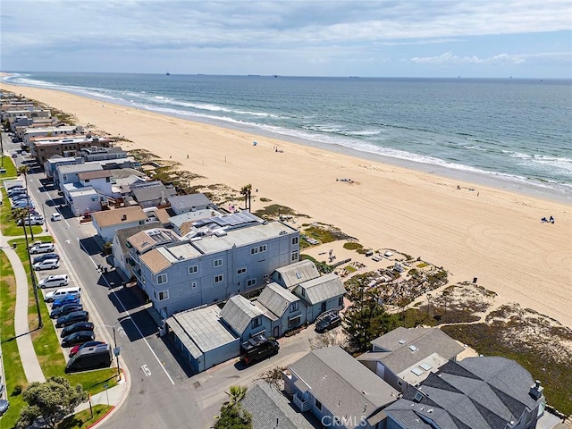 birds eye view of property featuring a water view and a beach view