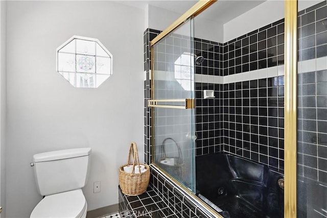 bathroom featuring toilet and tiled shower / bath