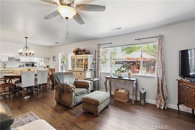 3571 White Wolf Ct, Merced, CA 95340 - living area with wood finished floors, a ceiling fan, a chandelier, and baseboards