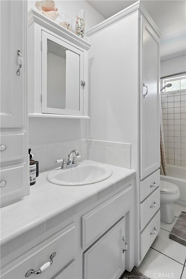 3571 White Wolf Ct, Merced, CA 95340 - full bathroom featuring vanity, tile patterned floors, toilet, and shower / bath combination with curtain