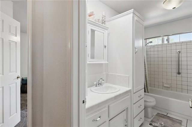 bathroom with tile patterned floors, toilet, shower / bathing tub combination, and vanity