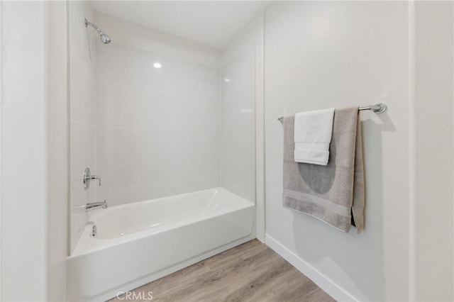 full bathroom featuring shower / bathtub combination, baseboards, and wood finished floors