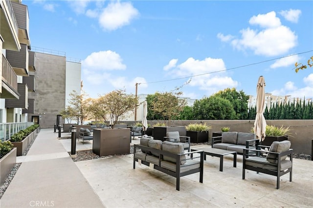 view of patio / terrace featuring outdoor lounge area and fence