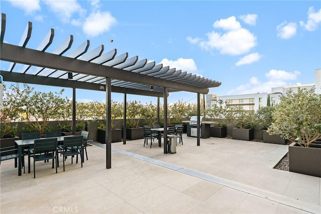 view of patio featuring outdoor dining space, a pergola, and area for grilling