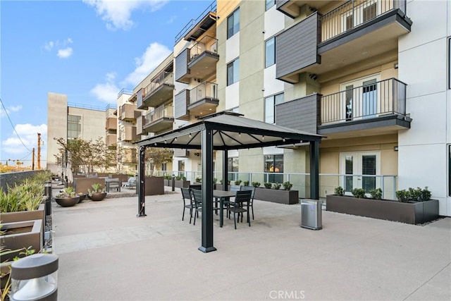view of home's community featuring outdoor dining area, a gazebo, and a patio area