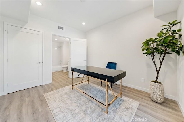 office featuring visible vents, recessed lighting, light wood-style flooring, and baseboards