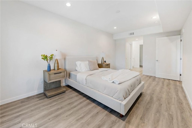 bedroom with recessed lighting, baseboards, and light wood-style flooring