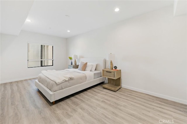 bedroom with recessed lighting, baseboards, and light wood-type flooring