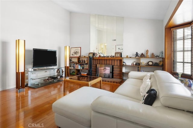 living area with wood finished floors and a fireplace