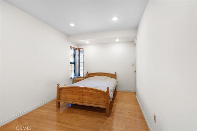bedroom featuring recessed lighting, baseboards, and light wood-type flooring