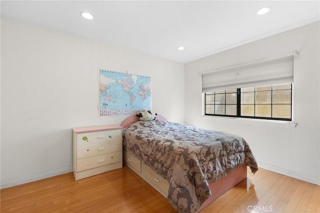 bedroom featuring baseboards, recessed lighting, and wood finished floors