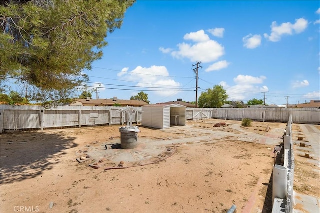 10341 N Loop Blvd, California City, CA 93505 - view of yard featuring an outdoor structure, a fenced backyard, and a storage shed