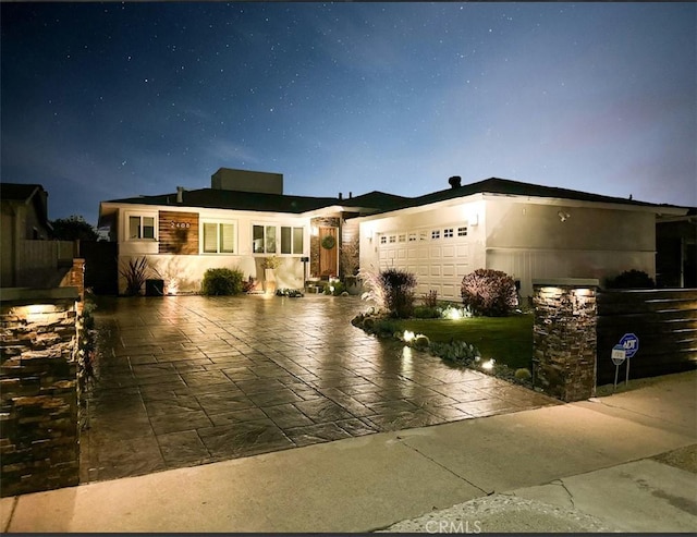 view of front of home with an attached garage and stucco siding