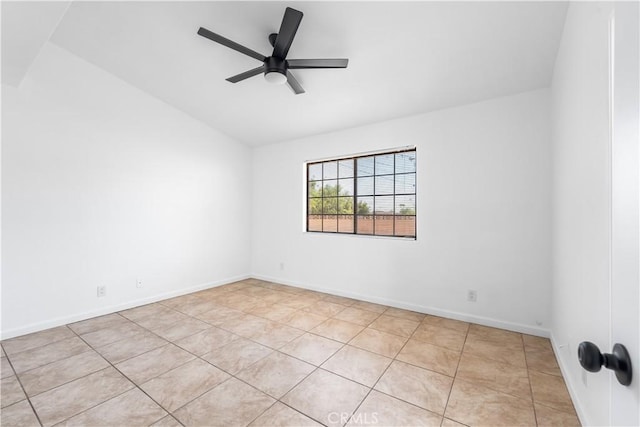 tiled spare room featuring baseboards, a ceiling fan, and vaulted ceiling