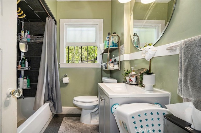 bathroom featuring shower / tub combo, tile patterned floors, baseboards, vanity, and toilet
