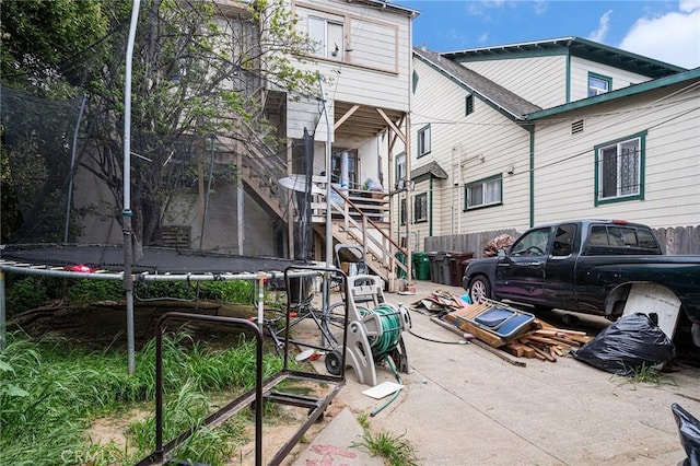 surrounding community with stairs and a trampoline