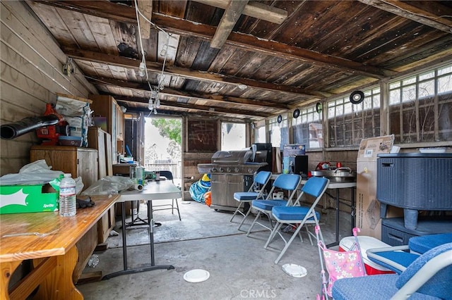 interior space with a workshop area and unfinished concrete flooring