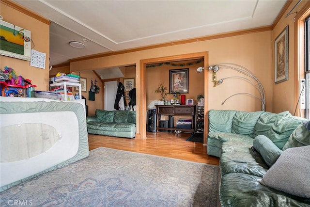 bedroom with crown molding and wood finished floors