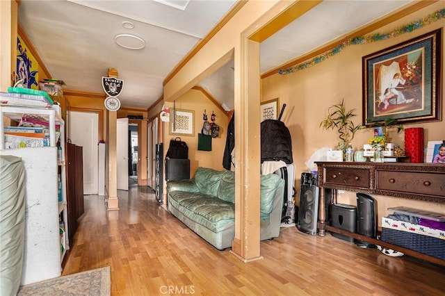 hall with crown molding and wood finished floors