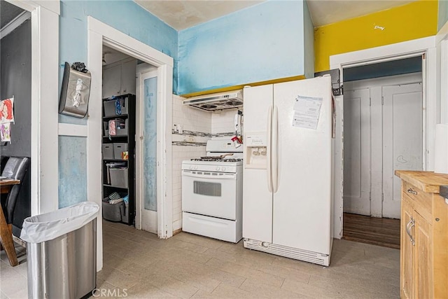 kitchen featuring butcher block countertops, decorative backsplash, exhaust hood, and white appliances