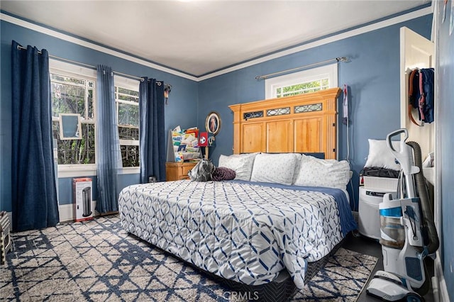 bedroom featuring radiator, multiple windows, and ornamental molding