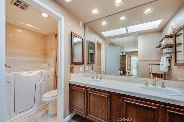 full bath featuring a sink, a skylight, a bath, and visible vents