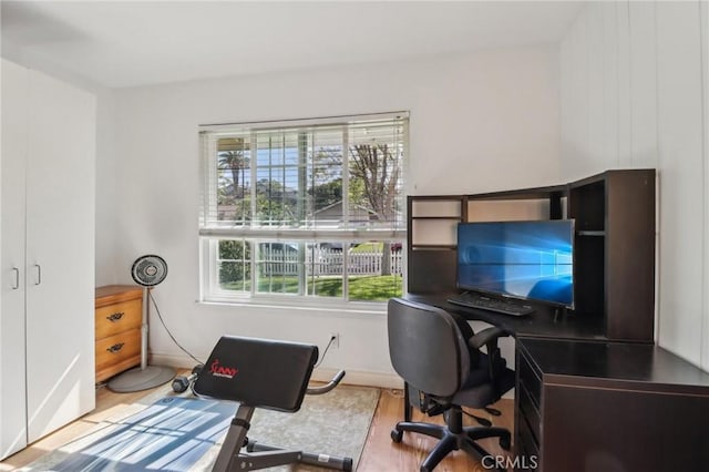 office area featuring baseboards and wood finished floors