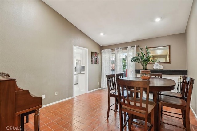 tiled dining room with baseboards, recessed lighting, and vaulted ceiling