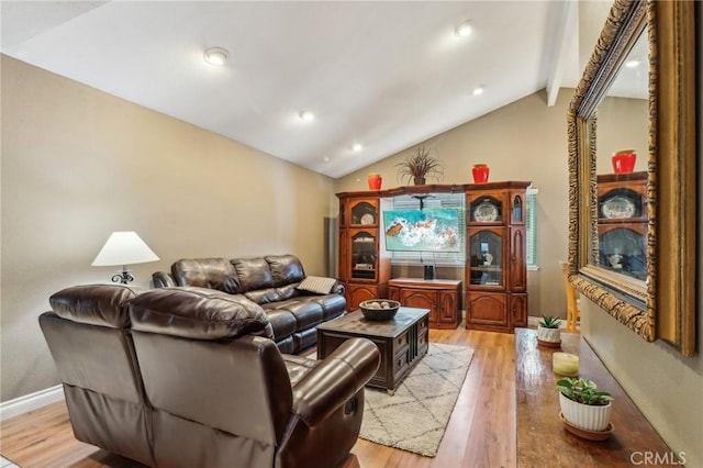 living room with recessed lighting, vaulted ceiling, and light wood finished floors