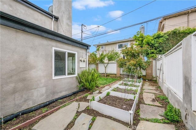 view of yard with a fenced backyard and a vegetable garden