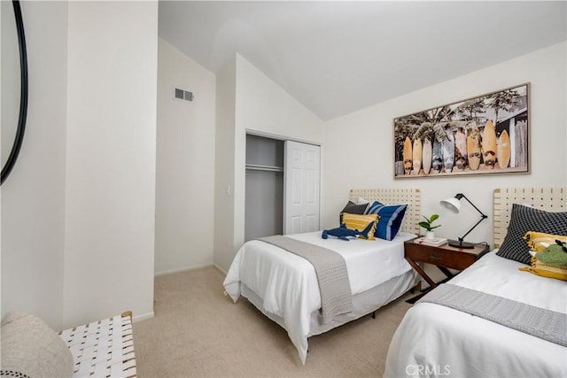 bedroom with visible vents, baseboards, a closet, lofted ceiling, and light carpet