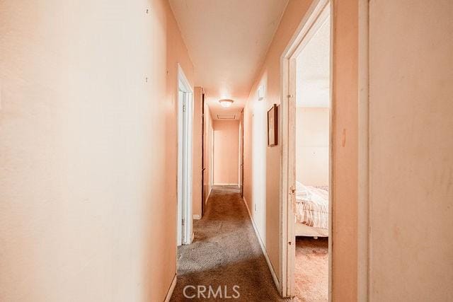 hall with carpet flooring and baseboards