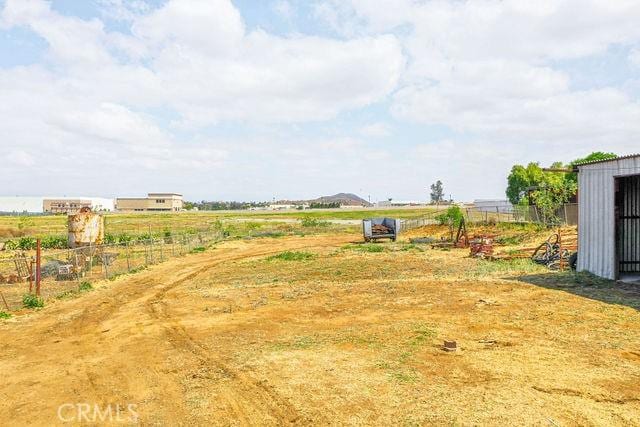 view of yard featuring fence and a rural view