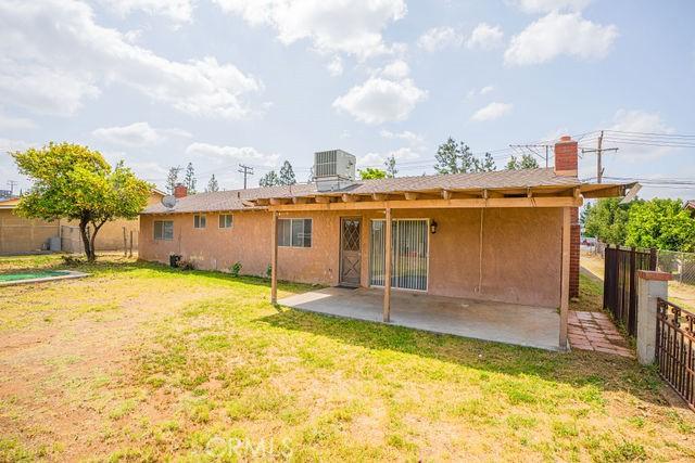 back of property with a patio area, fence, a yard, and cooling unit