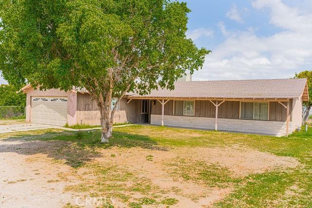 ranch-style home with a garage and driveway