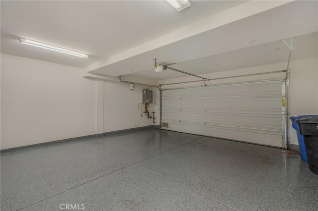 garage with water heater, visible vents, baseboards, and a garage door opener