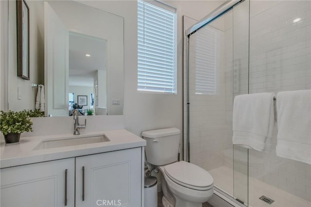 full bath with toilet, a shower stall, and vanity