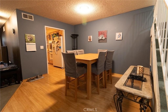 8060 Canby Ave Unit 2, Reseda, CA 91335 - dining room with light wood-type flooring and a textured ceiling