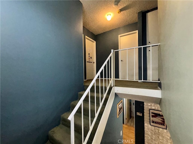 8060 Canby Ave Unit 2, Reseda, CA 91335 - staircase with a textured ceiling and a fireplace