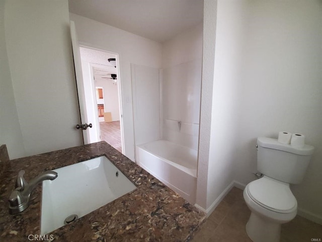 bathroom with baseboards, a sink, and toilet