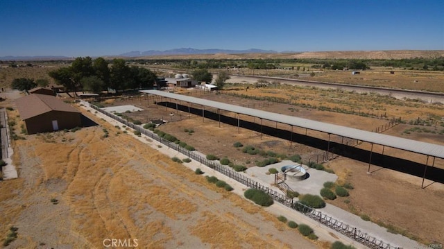 birds eye view of property featuring a mountain view, view of desert, and a rural view