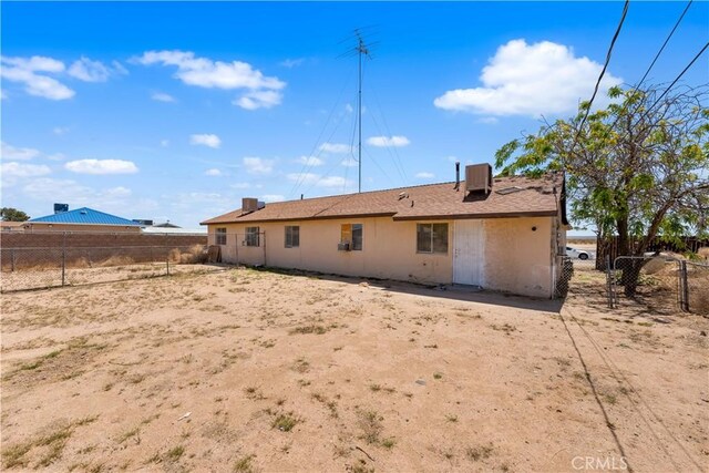back of property featuring central air condition unit and a fenced backyard