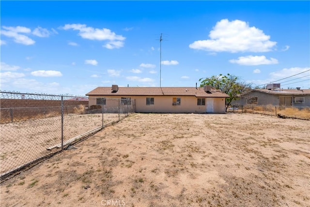 rear view of property featuring fence