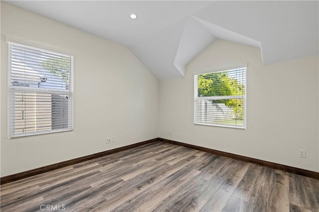 additional living space featuring recessed lighting, baseboards, wood finished floors, and lofted ceiling