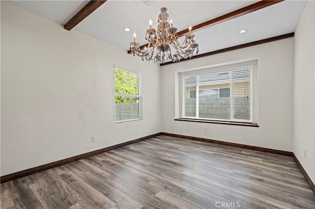 empty room with wood finished floors, beam ceiling, baseboards, recessed lighting, and a chandelier
