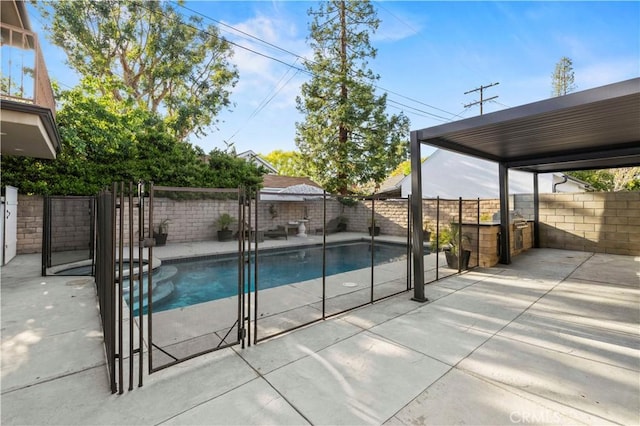 view of pool featuring a pool with connected hot tub, a fenced backyard, and a patio area