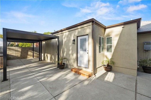 exterior space featuring fence, a patio, and stucco siding