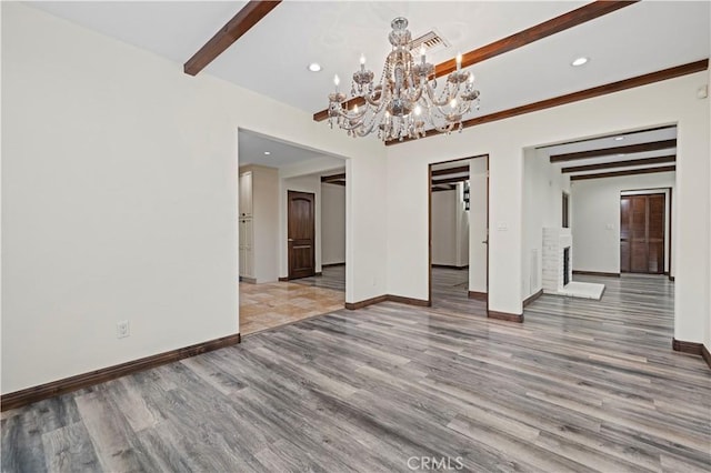 unfurnished dining area with baseboards, light wood finished floors, and a chandelier