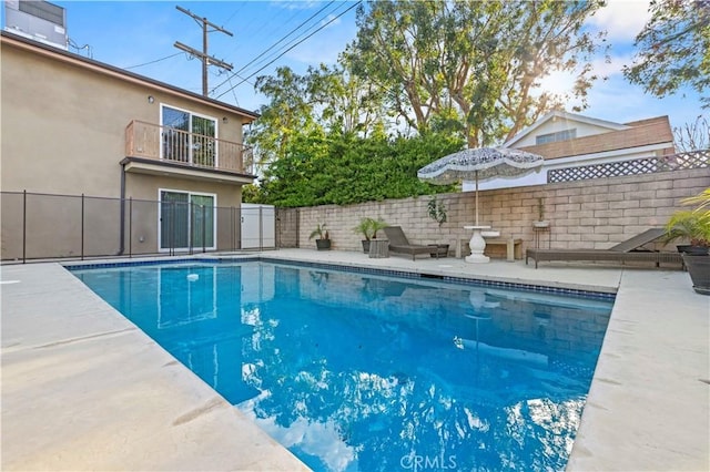 view of pool featuring a fenced in pool, a fenced backyard, and a patio