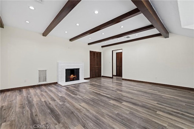 unfurnished living room featuring recessed lighting, beam ceiling, and wood finished floors